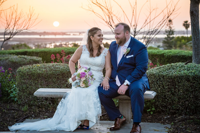 bride and groom sitting on a bench, sunset, bridal bouquet