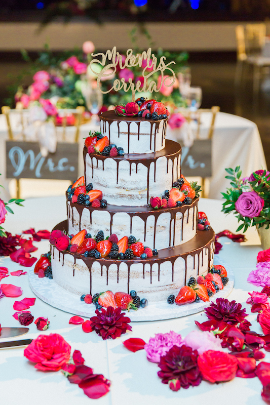 chocolate drip wedding cake, berries, rose petals