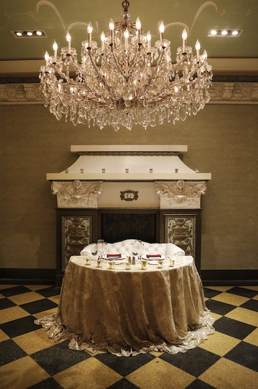 sweetheart table, crystal chandelier, fireplace