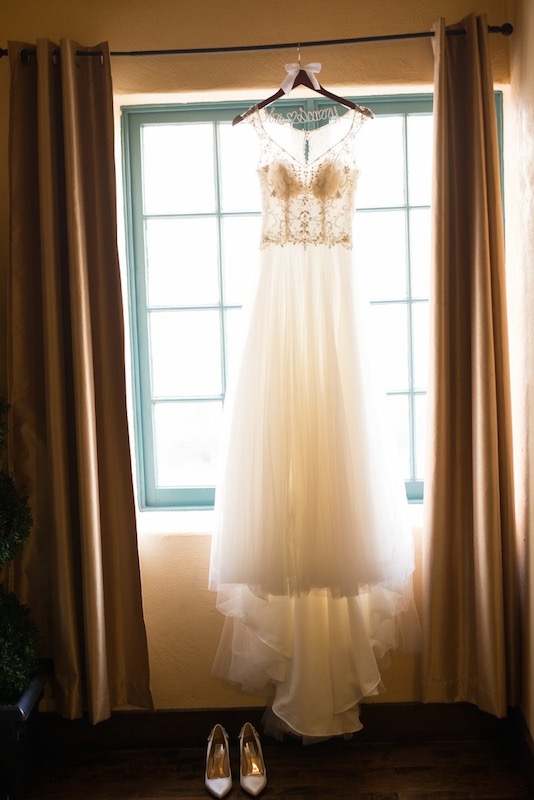 wedding dress hanging in window, shoes