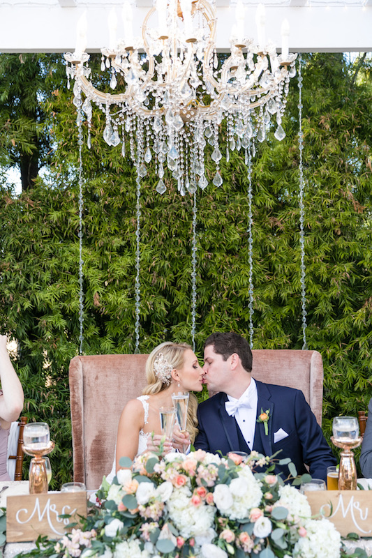 sweetheart table, bride, groom, chandelier