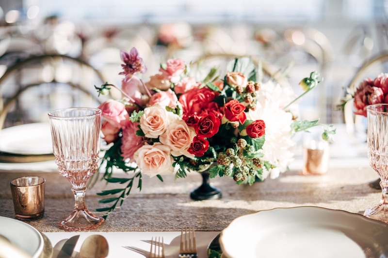 floral centerpiece, candles, table setting
