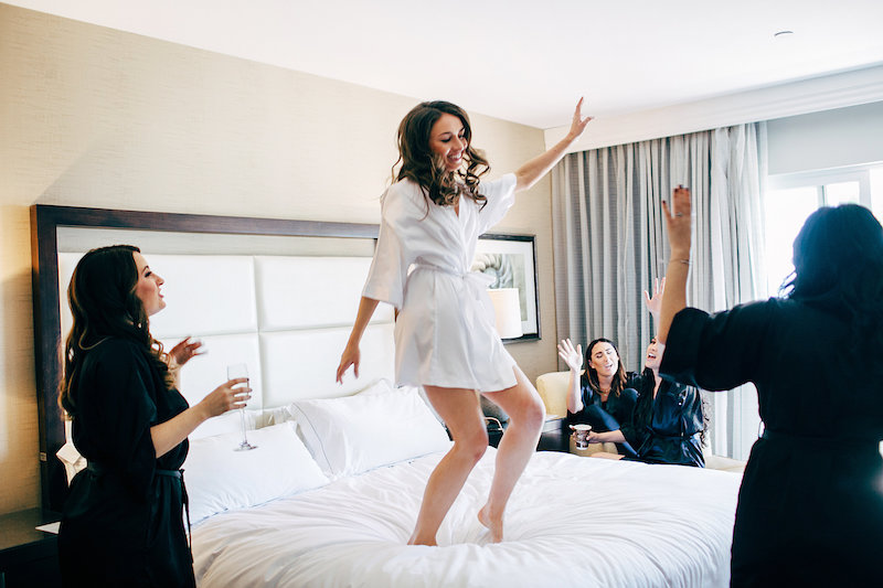 bride jumping on bed