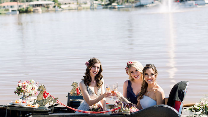 girls in gondola, toasting with champagne