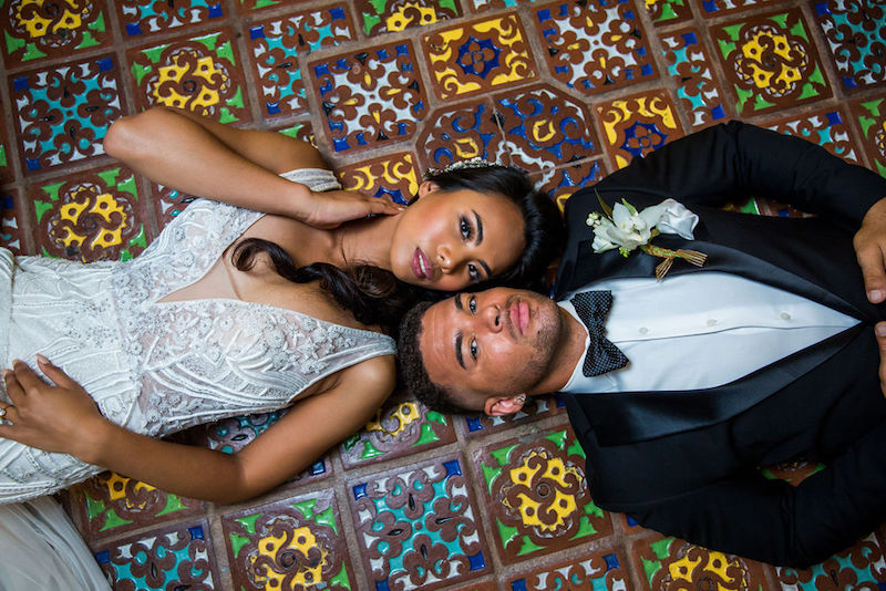bride and groom lying on floor