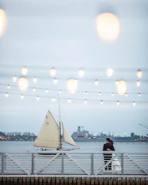bride and groom watching sailboat