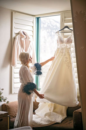 bride admiring wedding gown