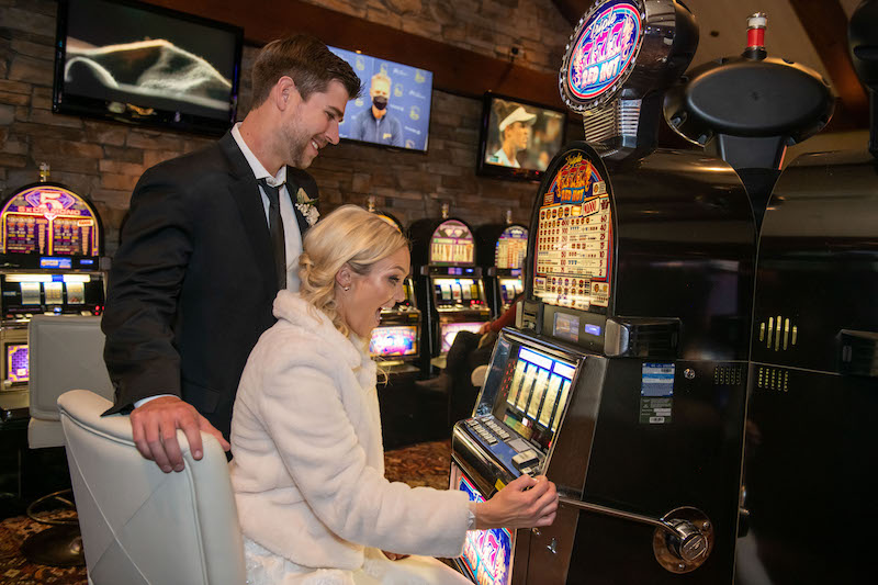 bride and groom playing slot machine